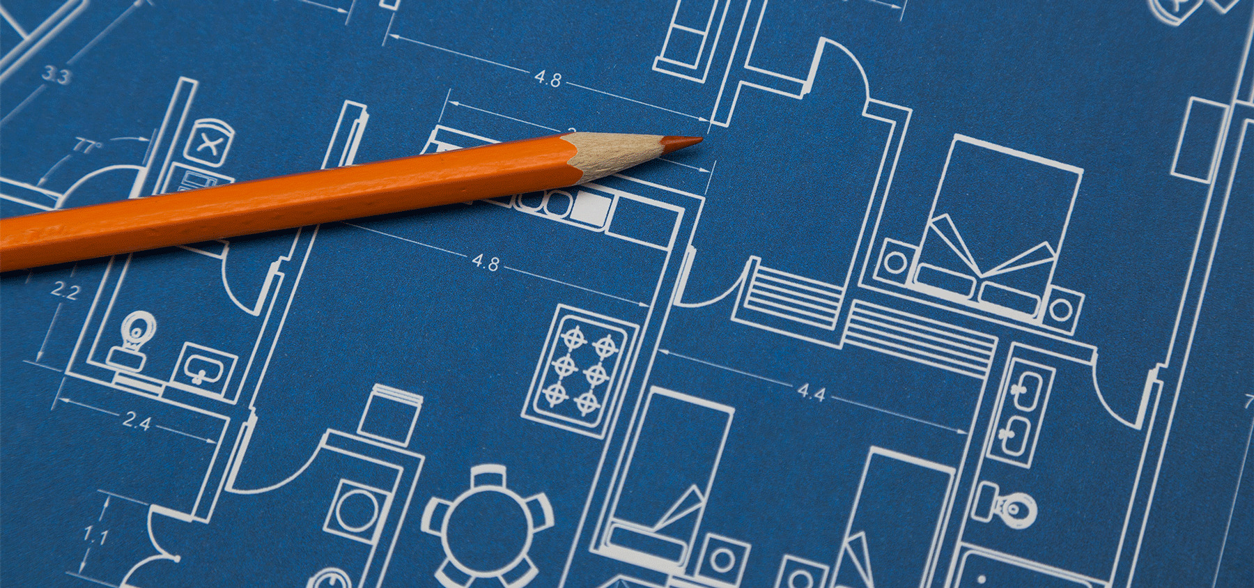 Blueprint of a building with a pencil next to it